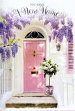 This image captures the feeling of arriving at a new Grove Park home just as the day settles into a soft, golden calm. A pale, chalk-painted pink front door glows with a gentle warmth, set into simple whitewashed walls that bounce the light back in a delicate halo around the entrance. Above and to the sides, lush wisteria cascades in strands of lavender and soft purple, its blooms hanging like little clusters of bells, dense and romantic. The foliage and flowers form a loose arch that hints at movement, as though stirred now and then by the kind of light breeze you'd feel walking from Grove Park station towards the riverside. At the foot of the door, a generous arrangement of white and cream roses sits in a weathered grey bucket, each bloom layered with velvety petals that seem to melt into one another. Sprigs of fresh green foliage weave between the roses, giving the bouquet a relaxed, garden-fresh character, as if it were gathered from a nearby cottage garden rather than a florist's workbench. A soft pink ribbon wraps around the bucket, tied in a gentle bow whose ends fall naturally across the step, echoing the rosy tone of the door. The interplay of pastel colours, muted shadows, and trailing vines creates a mood that is both tender and quietly celebratory. The scene feels like a heartfelt housewarming gesture-a floral welcome laid out ready for someone unlocking their Grove Park front door for the first time, carrying with them hope, gratitude, and the promise of many cosy evenings to come.